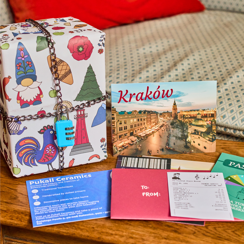 Padlock'd Poland: a gift wrapped in gnome-print paper and chained shut beside a Kraków postcard and the envelope contents
